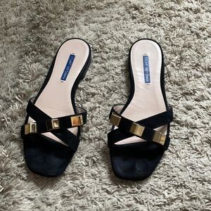 Stuart Weitzman flat sandals.